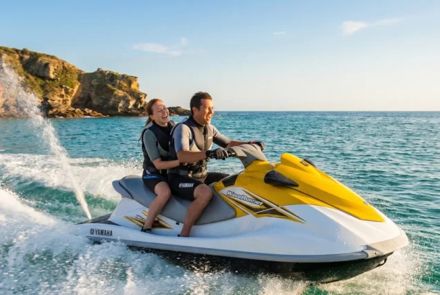 Couple riding together on a JET SKI personal watercraft in Bali waters